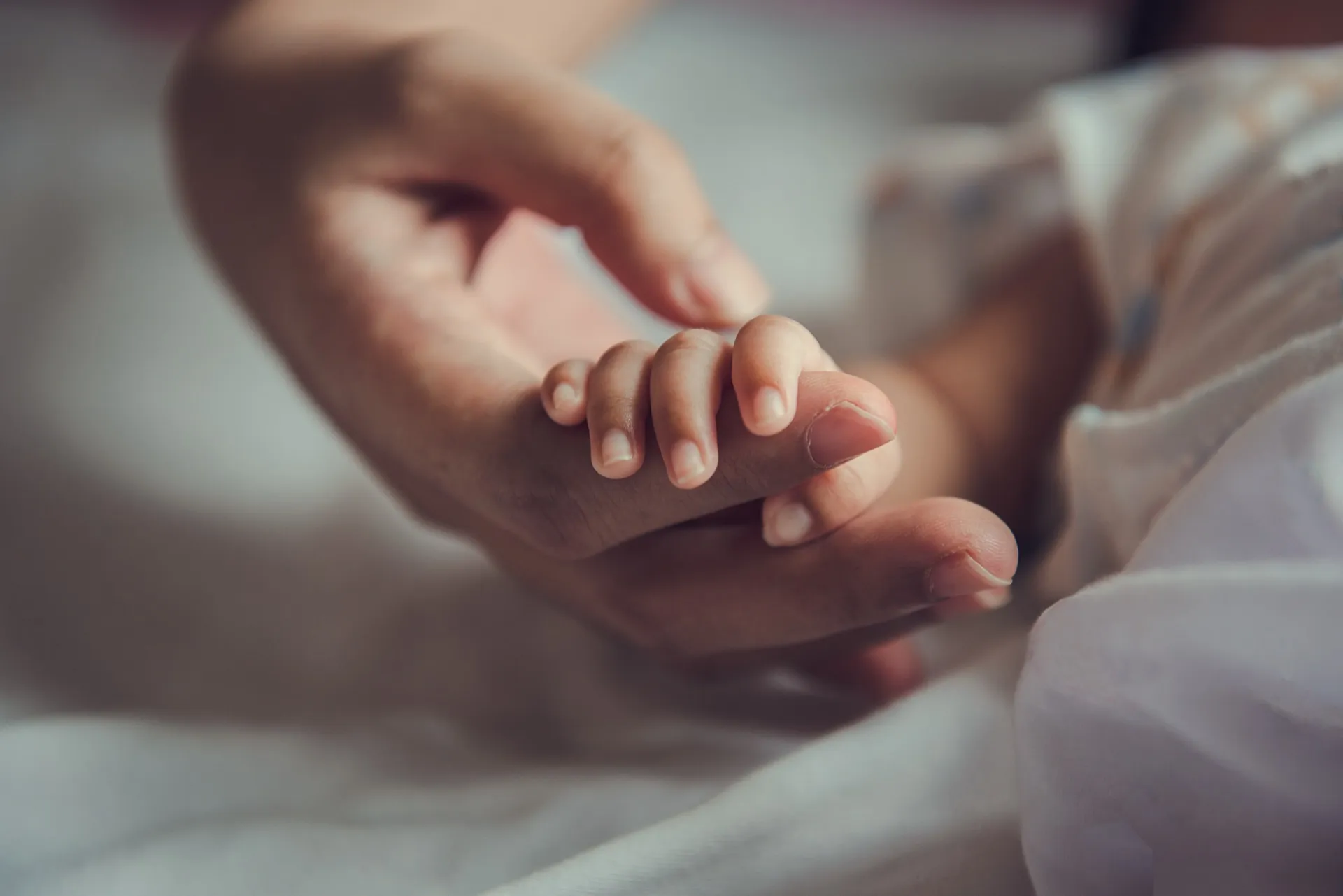 A mother holding her newborn baby shortly after birth